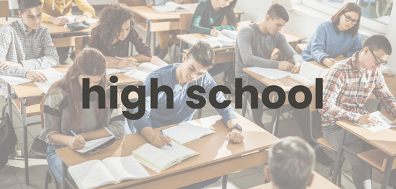teenagers sitting and working at desks with the word high school